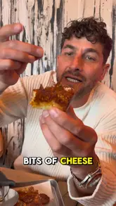 A creator visits Pop Kitchen in Exeter to review their viral Detroit-style pizzas and a Cuban sandwich. The video features close-ups of the food, highlighting the crispy cheese edges, and includes the creator's enthusiastic commentary on the quality of the food and the independent nature of the venue.