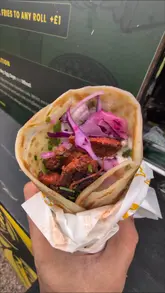 A fast-paced, music-driven reel showcasing the preparation and consumption of Indian street food from the vendor KoolKata at Herbert's Yard. The video features close-ups of the food being assembled, including a tandoori chicken wrap and a vegetarian bowl, followed by a customer enjoying the meal.