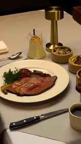 A single, slow-motion, high-quality shot of a Sunday roast being served at a restaurant, featuring roast beef, Yorkshire pudding, and vegetables.