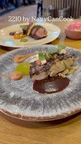 A polished montage showcasing a variety of elevated Caribbean dishes and cocktails at 2210 by NattyCanCook in Herne Hill. The video focuses on high-quality close-ups of plated food and drinks, interspersed with brief shots of the restaurant interior.