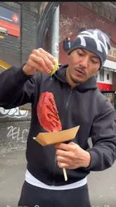 A high-energy review of a street food vendor specializing in fruit-based snacks like 'Pine Pops' and 'Water Pops' topped with chamoy, tajin, and other seasonings. The video follows the creator as they try the items, showing the preparation process and their reaction to the flavors.