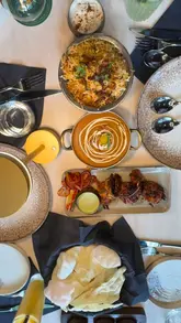 A review of Masakali London, an Indian restaurant in Euston, highlighting the biryani and tiger tandoori prawns. The video features close-up shots of the dishes and the restaurant's interior, accompanied by a voiceover and text overlays.