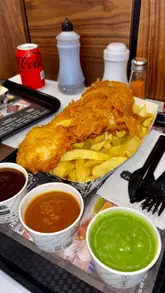 A promotional video for Mother Hubbard's fish and chip shop in Cardiff, featuring a montage of the exterior, interior, menu, and various food items including fish and chips, prawns, and sides.