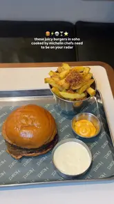 A short video featuring a creator enjoying a burger and fries at Heard Burger in Soho. The video includes shots of the food, the cooking process on the grill, and the restaurant's exterior.