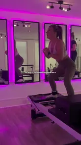 A short, aesthetic montage showcasing a Pilates studio, featuring the creator performing various exercises on a reformer machine. The video highlights the studio's interior, including the equipment and the overall atmosphere.