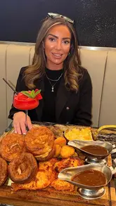 A short, montage-style video showcasing a Sunday roast experience at Zouk. The video features shots of the restaurant exterior, the menu, a cocktail, a large sharing platter of roast meats with sides, and a dessert.