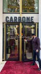A high-quality, cinematic montage showcasing the dining experience at Carbone London. The video highlights the elegant interior, tableside service, and signature dishes like the Caesar salad and rigatoni alla vodka, creating a sophisticated and inviting atmosphere.