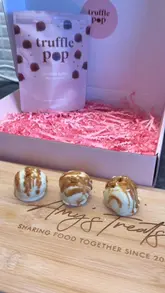 A creator reviews the new Biscoff-flavored Truffle Pop, showcasing the product packaging, the texture of the truffle, and demonstrating the taste test.
