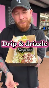 A creator reviews indulgent loaded desserts, including a bubble waffle and a loaded croissant, at Drip & Drizzle located in Kargo MKT, Manchester. The video features close-ups of the food preparation and the creator tasting the items.