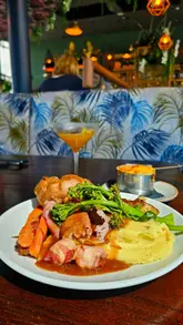 A montage showcasing the Sunday roast menu, cocktails, and scenic views at Altitude 28 in Swansea.