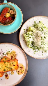 The creator visits Brothers Exeter to review their new evening menu, featuring a variety of dishes including steak, lamb, halloumi, and dessert, accompanied by unlimited frites.