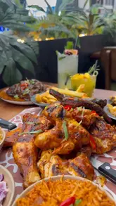 A short, punchy reel showcasing a large sharing platter at Afrikana restaurant, featuring various grilled meats, sides, and mocktails.
