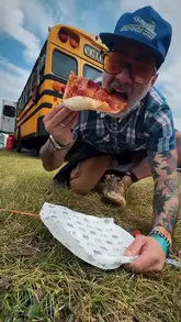 A high-energy vlog following a creator's experience at the Slam Dunk music festival, focusing on the various food vendors present. The video features quick cuts between the creator trying different dishes like pizza, loaded fries, ribs, dumplings, and fried chicken, interspersed with shots of the festival atmosphere and live music performances.