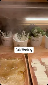 A montage-style video showcasing the extensive food selection at Daiu, a buffet restaurant offering a mix of Korean BBQ, hot pot, sushi, dim sum, and various international dishes. The video pans across the different food stations, highlighting the variety of raw ingredients, prepared dishes, and dessert options available to diners.