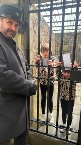 A family visits Inveraray Jail, exploring the historical prison exhibits, interacting with costumed characters, and touring the cells and courtroom.