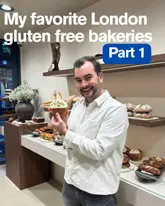 A creator presents a listicle-style video introducing a series on gluten-free bakeries in London, standing in front of a bakery display case while holding a pastry.
