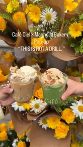 A short, aesthetic reel showcasing a pop-up collaboration between Café Ciel and Magnolia Bakery in London. The video features close-up shots of signature desserts like banana pudding and sticky toffee pudding, as well as iced drinks topped with pudding, set against a backdrop of floral decorations.