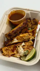 A short review of Jimmy Macks street food stall, featuring close-ups of nachos and tacos in takeaway containers, along with a shot of the menu board.
