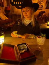 A high-quality, atmospheric shot capturing an immersive saloon experience. The lighting and styling perfectly evoke the theme, with the subject engaged in the activity, making the venue look like a fun, interactive night out.