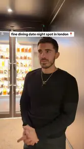 A creator visits Scully St. James in London, providing a review of their fine dining experience. The video features a variety of unique, artistically plated dishes, including golden kiwis, a tomato salad, mushroom 'popcorn chicken', an arepa with aubergine, and a burger, ending with a palate cleanser. The creator provides commentary on the flavors and textures of each dish.