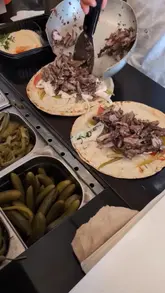 A creator visits a shawarma spot on Edgware Road, London, to review the food. The video features the creator talking to the camera, shots of the shawarma being prepared, and a taste test.
