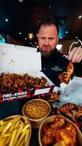A creator reviews a kebab shop in Oxford, sampling various items including a large kebab, peri-peri chicken, rice, chips, and a milkshake. The video features close-up shots of the food and the creator's reactions, with a focus on the quality and taste of the takeaway meal.