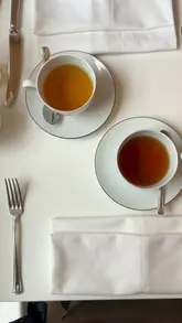 A short, aesthetic video showcasing the interior and products of a tea house in Covent Garden. The footage includes shots of the tea room, tea being poured, and a selection of cakes, set to music with text overlays.