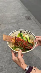 A promotional montage for Noodle Inn's new Covent Garden location, featuring the hand-pulled noodle preparation process, various noodle dishes, dumplings, and the restaurant interior.