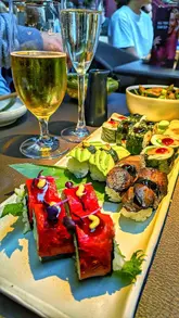 A promotional reel showcasing a bottomless brunch experience at Sticks n Sushi in Manchester, featuring a variety of vegan sushi, bites, and sticks, along with unlimited drinks and a live DJ.