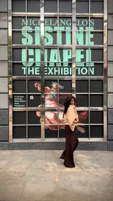 A short, energetic video showcasing a visit to the Michelangelo's Sistine Chapel exhibition in London. The creator walks through the space, highlighting the detailed art reproductions, the intimate atmosphere, and the on-site bar, providing a clear sense of the visitor experience.