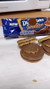 A short, handheld review of the new McVitie's Jaffa Cakes flavoured Chocolate Digestives, featuring a close-up look at the biscuit's texture and a commentary on its flavour profile.