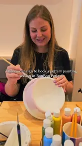A couple visits a pottery painting cafe, showing the process of selecting pottery, painting it, and enjoying drinks, highlighting the relaxing and creative atmosphere.