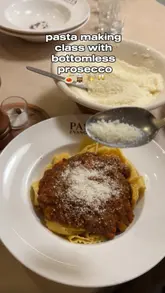 A couple attends a pasta-making class at Pasta Evangelists, documenting the experience from arrival to the final meal. The video features the chef's instruction, the hands-on process of making pasta, the starters, the main course, and a concluding limoncello shot.