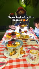 A family-focused video showcasing a Paddington-themed afternoon tea experience at Brigit's Bakery. The video features the themed decor, the table setting, and the various food items including marmalade sandwiches and cupcakes, highlighting the experience as a family-friendly outing.