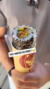 A short, punchy video showcasing a unique 'sushi pop' concept at Boxpark Shoreditch, demonstrating the convenience of the packaging and highlighting the prawn tempura roll.