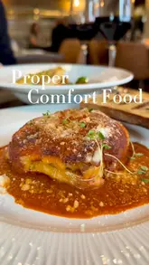 A montage-style promotional video for The Hawk in Ponteland, featuring close-up shots of various dishes including lasagna, scallops, and sticky toffee pudding, interspersed with shots of the restaurant's interior and exterior.