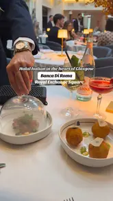 A montage video showcasing a visit to Banca Di Roma in Glasgow, highlighting the restaurant's elegant interior, cocktail service, and a variety of Italian dishes including starters, mains, and interactive desserts.