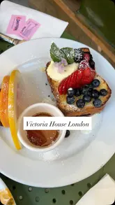 A promotional reel for Victoria House Coffee & Food in London, featuring close-up shots of brunch dishes like French toast and a full English breakfast, alongside clips of the cafe's interior and exterior.