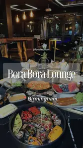 A montage video showcasing a Turkish breakfast experience at Bora Bora Lounge in Birmingham, featuring close-ups of various dishes, the interior decor, and drinks.