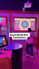 A fast-paced promotional video for Boom Battle Bar in Canterbury, highlighting the activity bundle which includes games like AR darts, mini golf, and karaoke, alongside food and drinks.