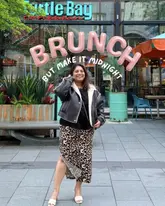 A promotional image featuring a creator posing in front of a Turtle Bay restaurant, using text overlays to advertise their 'late night' bottomless brunch offering.