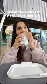 A creator visits a burrito shop to review their 'Power Burrito,' showing the assembly process and giving a positive review of the taste and the brand's charitable initiative.