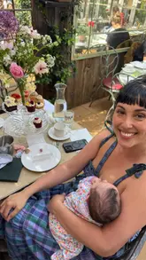 A family-focused vlog capturing an afternoon tea experience at a garden-themed venue. The video features shots of the parents and baby, the floral-themed afternoon tea stand, and the greenhouse interior.