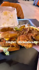 A vlog-style review of a new fast-food chicken shop, Zinglet, in Birkenhead. The video features shots of the exterior, the menu, the interior, and close-ups of the food, including burgers and chicken tenders.