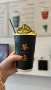 A short, handheld vlog-style video featuring a dog visiting Chayan, a matcha cafe in Edinburgh. The video captures the entrance, the interior, the menu, and a final shot of a matcha drink.