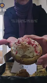 A short, engaging unboxing video featuring a delivery from a home bakery called Roll On Bakers. The video highlights the premium packaging and the appetizing appearance of the cookies and cinnamon buns, focusing on their texture and presentation.