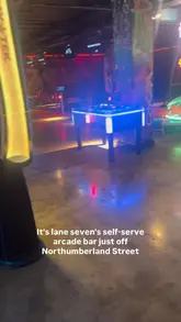 The video is a vlog-style tour of ML7, an arcade bar in Newcastle. The creator walks through the venue, demonstrating the self-service bar and various arcade games like bowling, basketball, and Hungry Hippos, highlighting its suitability for families, friends, and date nights.
