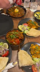 A group of friends visits Mishti Desh to celebrate, featuring a variety of Indian and Bengali dishes like biryani and murgi masala. The video is a casual, vlog-style review focusing on the social experience and the food.