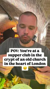 The video features two creators visiting a supper club hosted in a church crypt in London. They sample a variety of dishes from different cuisines, including a vegan sweet potato tostada, lamb chops, and a lemon curd tiramisu. The video captures the atmosphere of the event and the creators' enthusiastic reactions to the food, providing a clear sense of the experience.