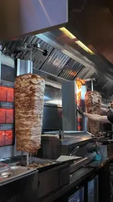 A review of Cha Cha, a shawarma spot in Edinburgh. The video features the preparation of the shawarma, a look at the menu, and the creator trying the food.